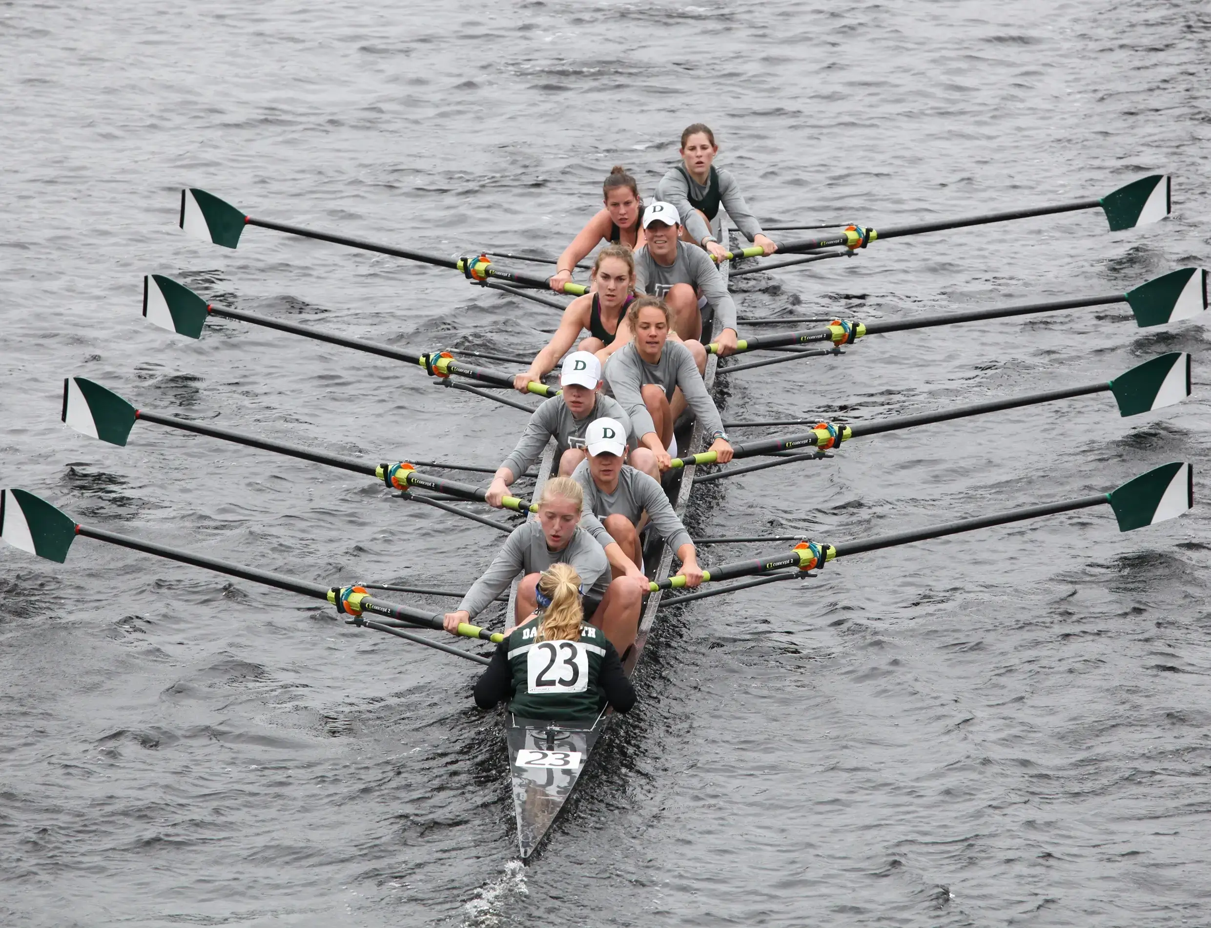 Rowing team in sync on the water during a race.